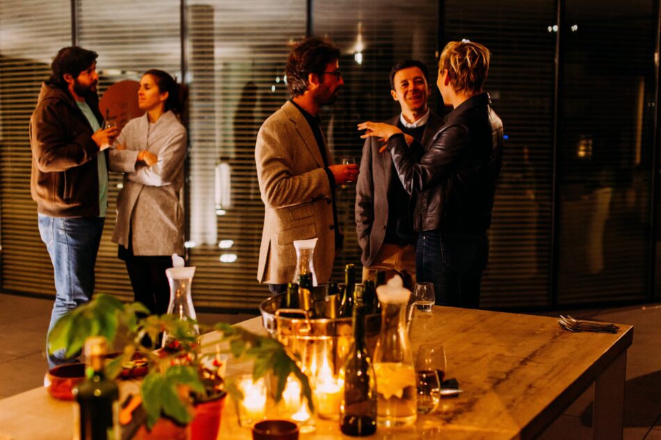 people talking at christmas party in candlelight.