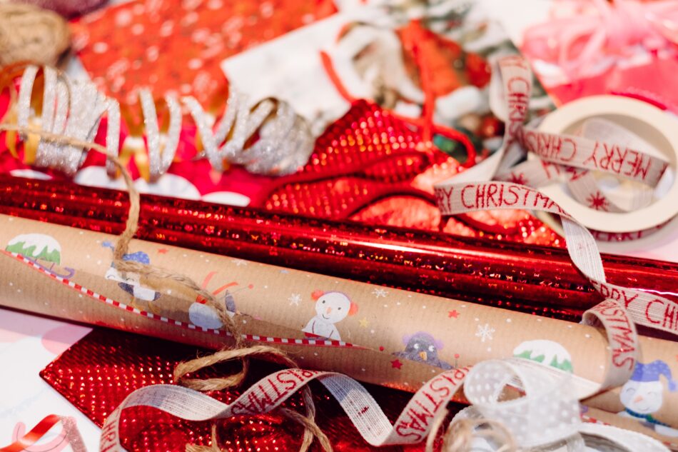 christmas wrapping paper and tags on table.