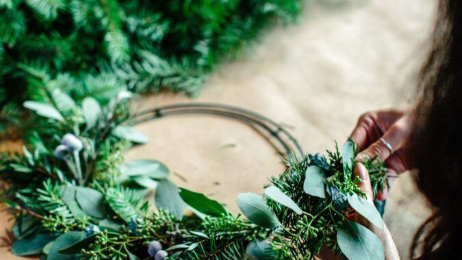 woman making Christmas wreath.
