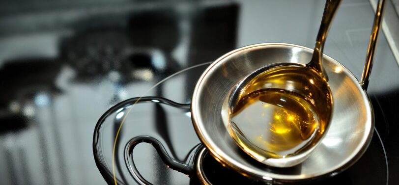 cooking oil in a bowl on top of oven.