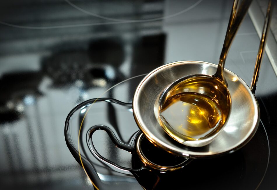 cooking oil in a bowl on top of oven.