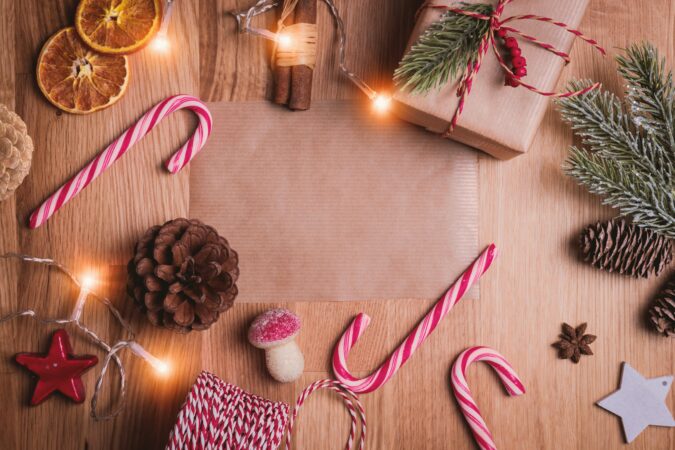 brown paper with candy canes and Christmas lights surrounding it.