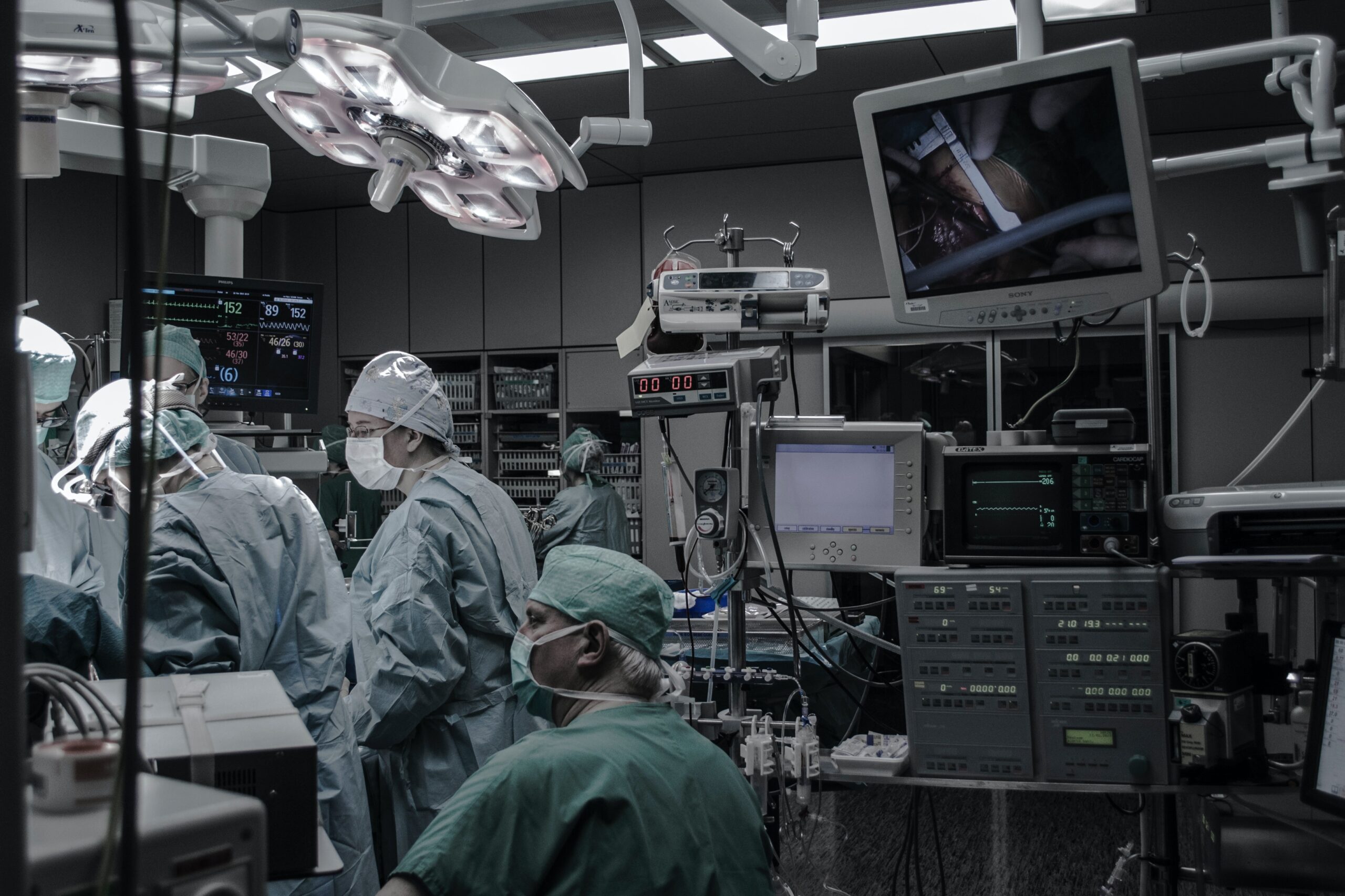 doctors and surgeons at work in operating theatre.