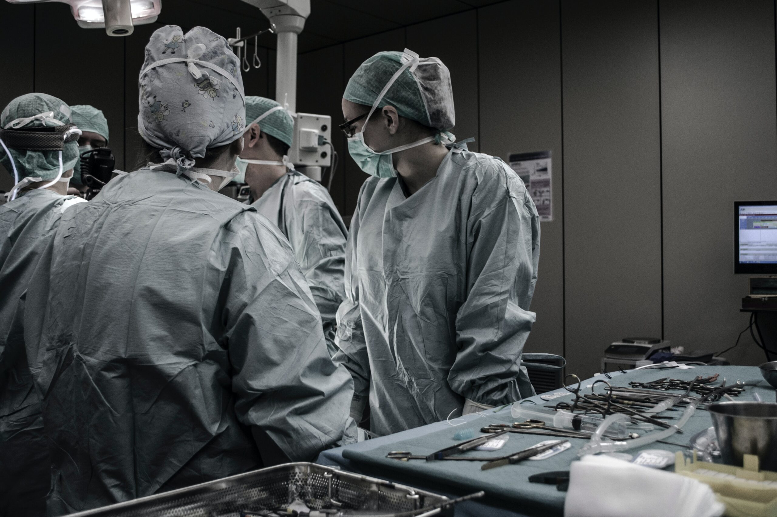 surgeons in operating theatre wearing masks.