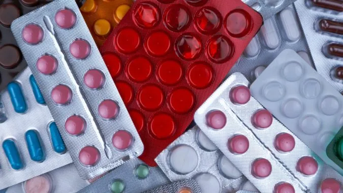 full packets of pills and medication capsules.