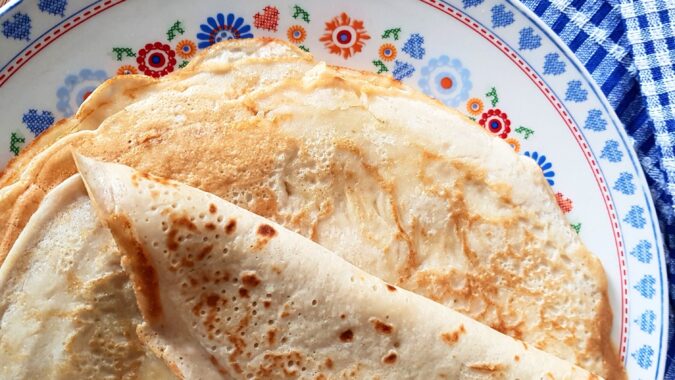 stack of pancakes on flowery plate.