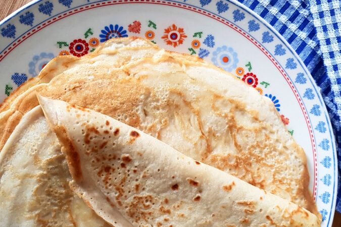 stack of pancakes on flowery plate.