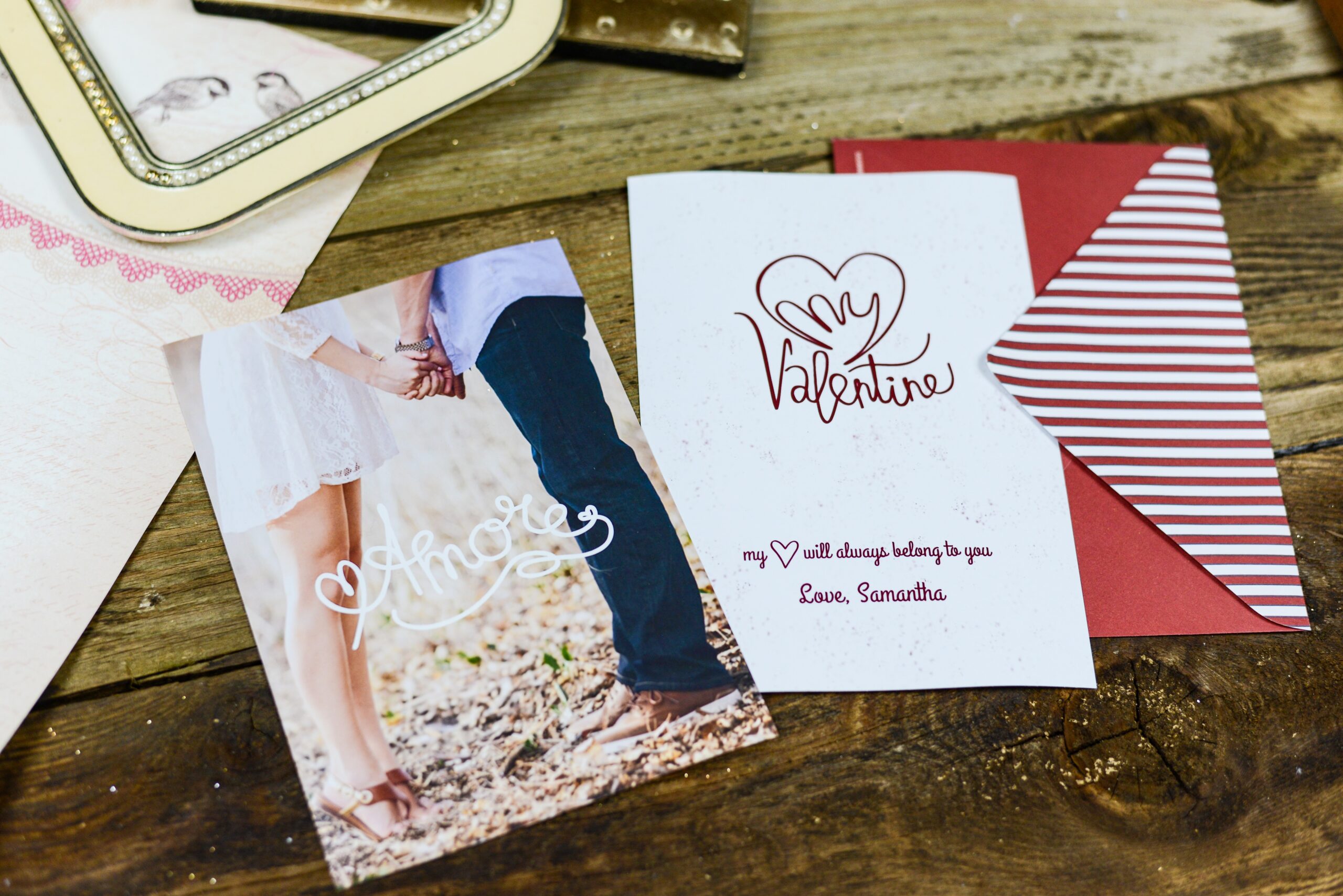 two valentine's day cards on wooden table.