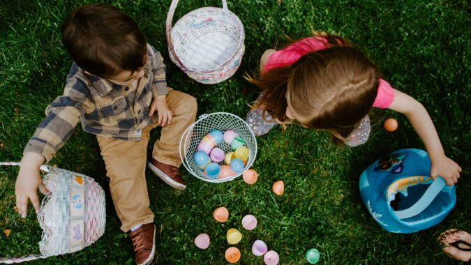 two kids with baskets of easter eggs.