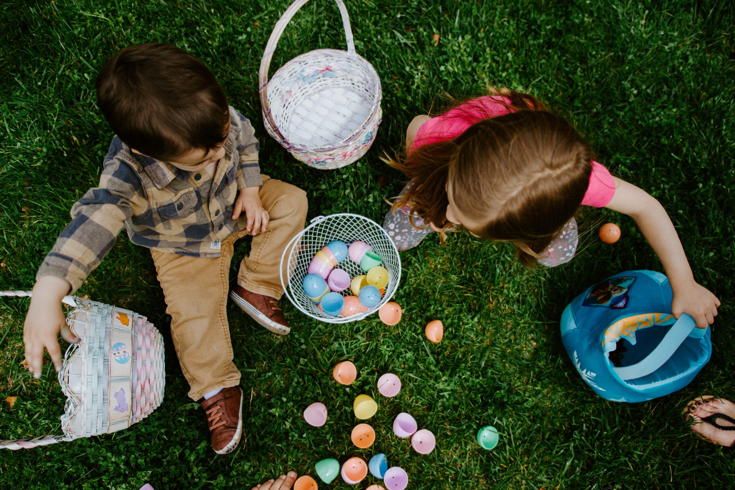 two kids with baskets of easter eggs.