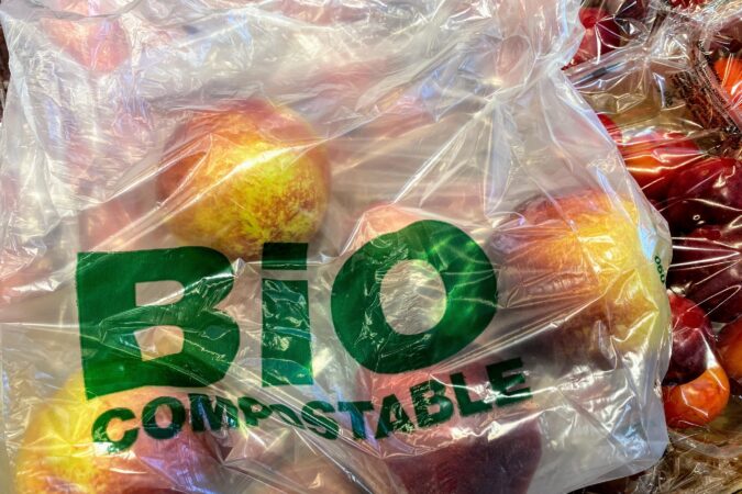 bio compostable plastic bag with apples inside.