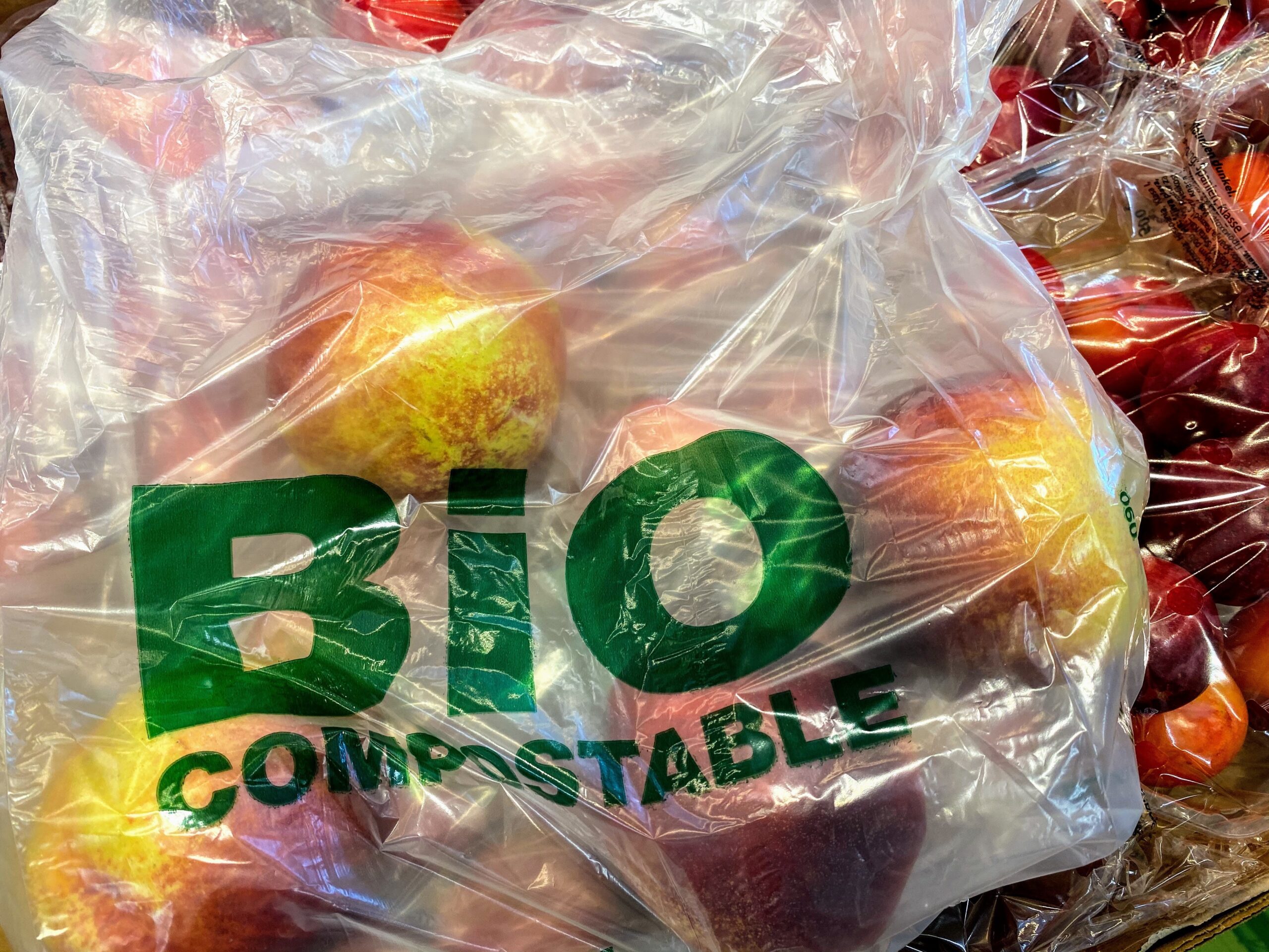 bio compostable plastic bag with apples inside.