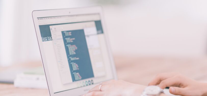 woman's hands typing on a laptop.