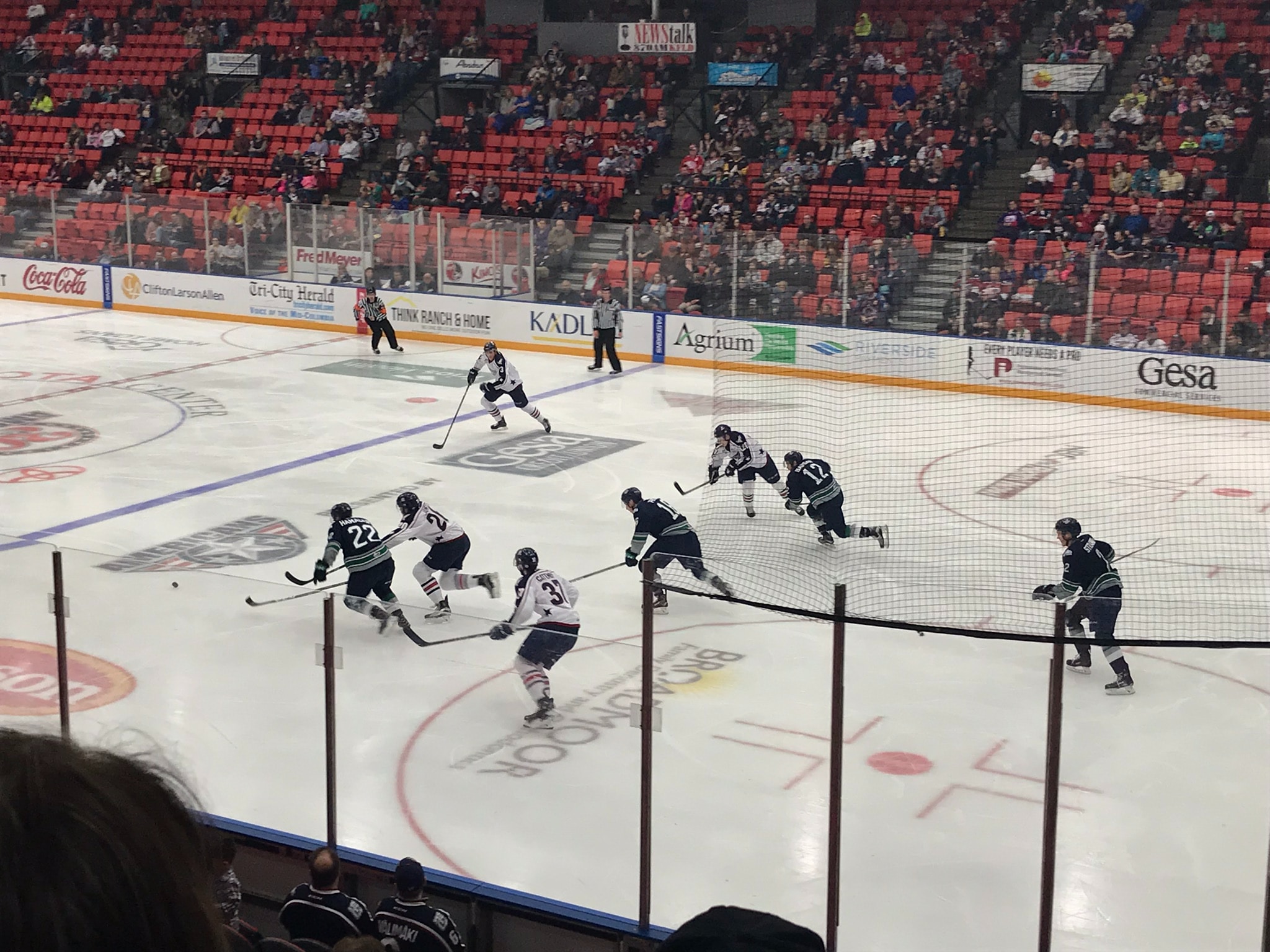 ice hockey game with acrylic barriers round the edge.