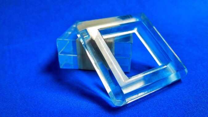 two acrylic squares leaning on each other.