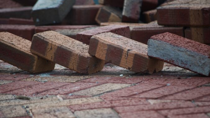four bricks leaning on each other.