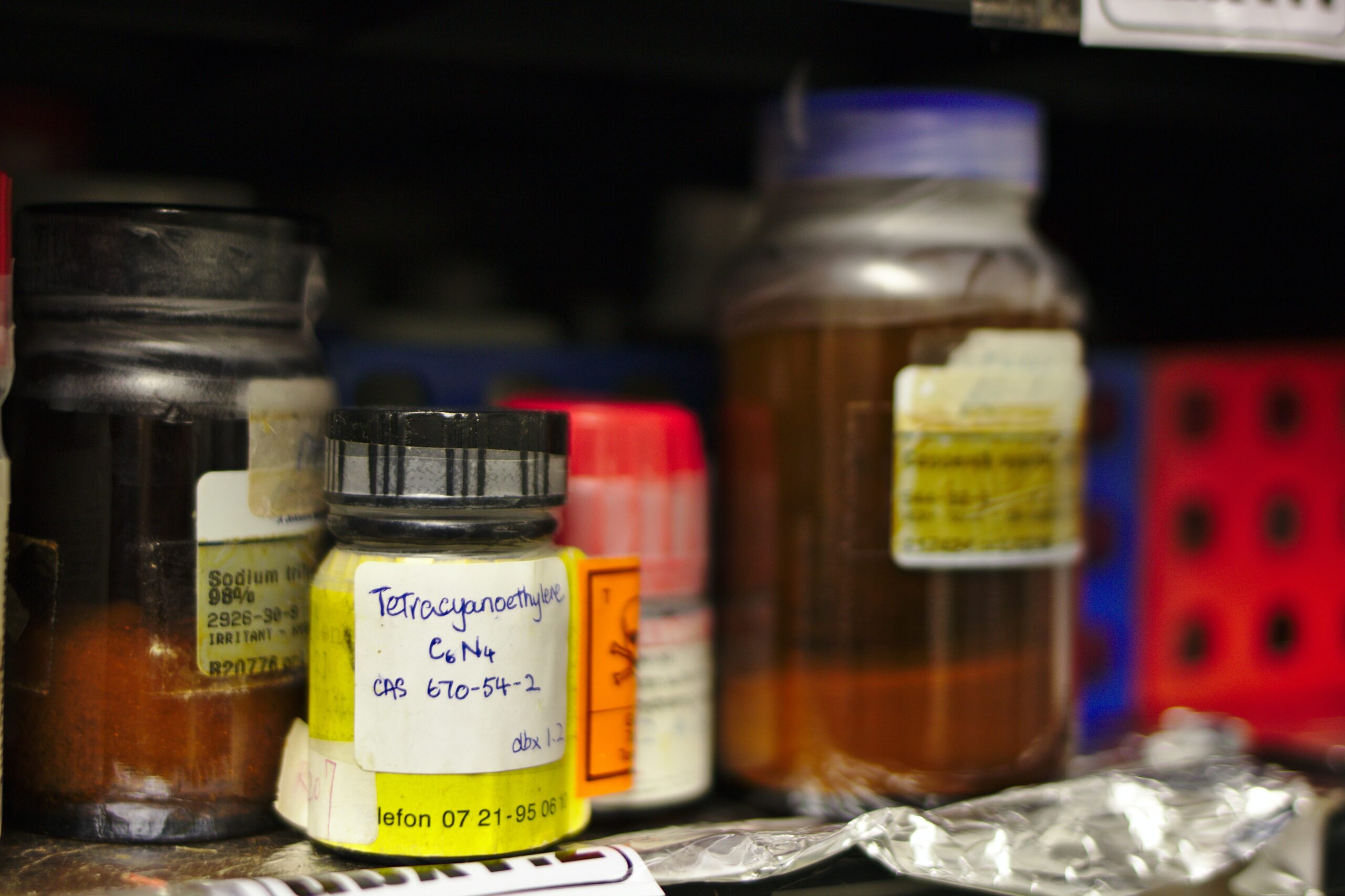 bottles and jars of chemicals on a shelf.