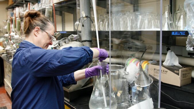 woman in laboratory working with chemicals.