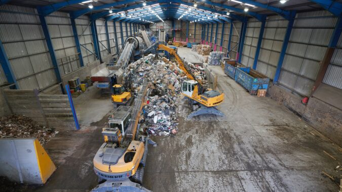 materials recovery facility with diggers moving waste,