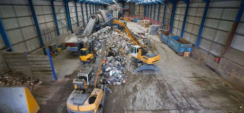 materials recovery facility with diggers moving waste,