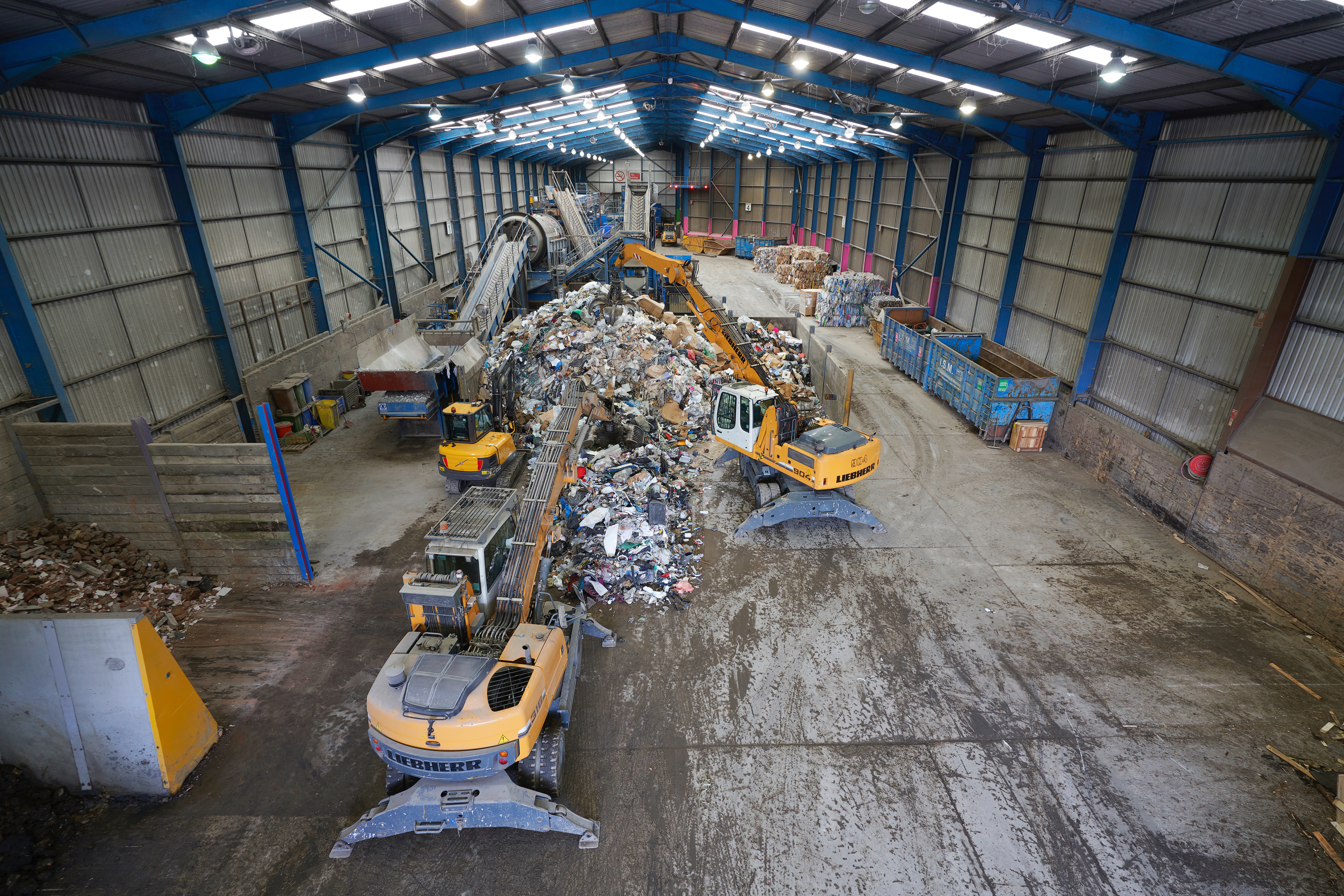 materials recovery facility with diggers moving waste,