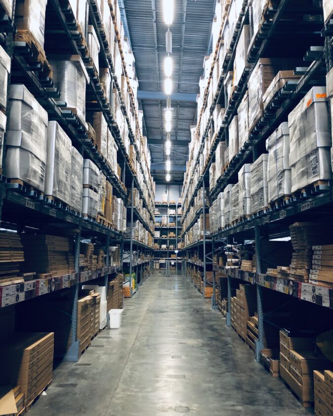 packages and boxes on shelves in a warehouse.