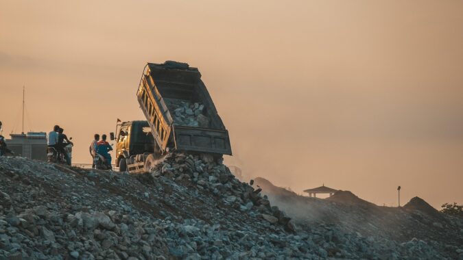 truck dumping waste in a landfill site.