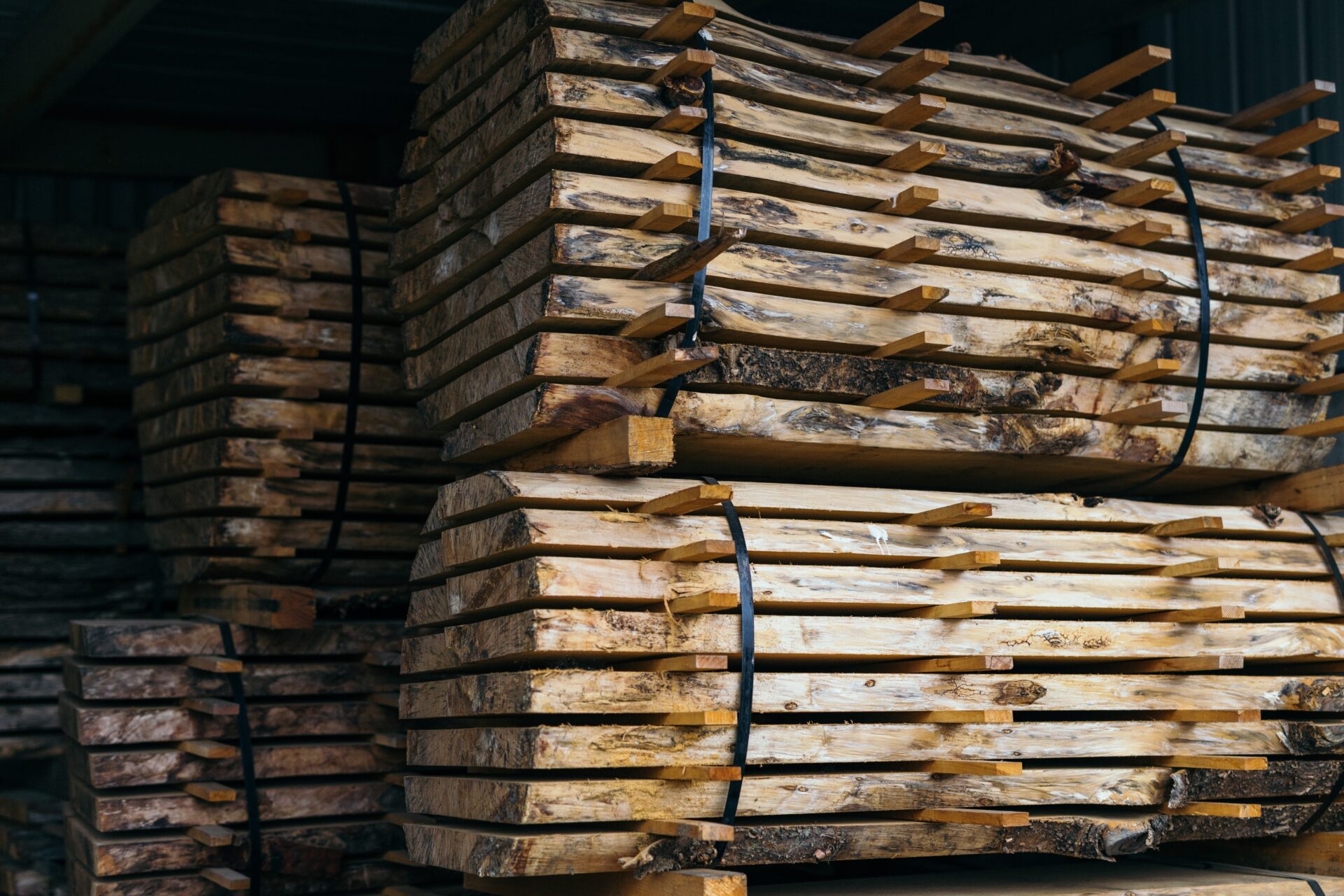 logs piled up in barn.