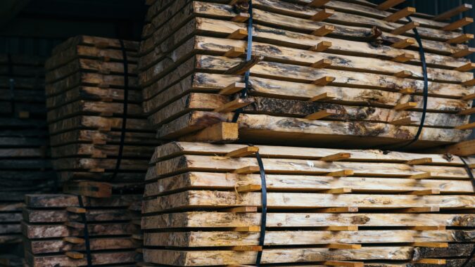 logs piled up in barn.