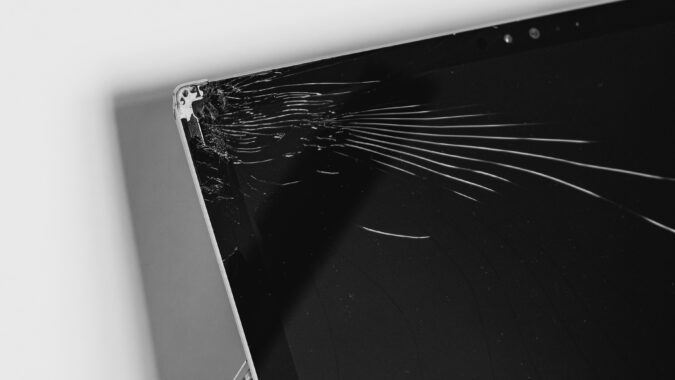 black laptop with a cracked screen.