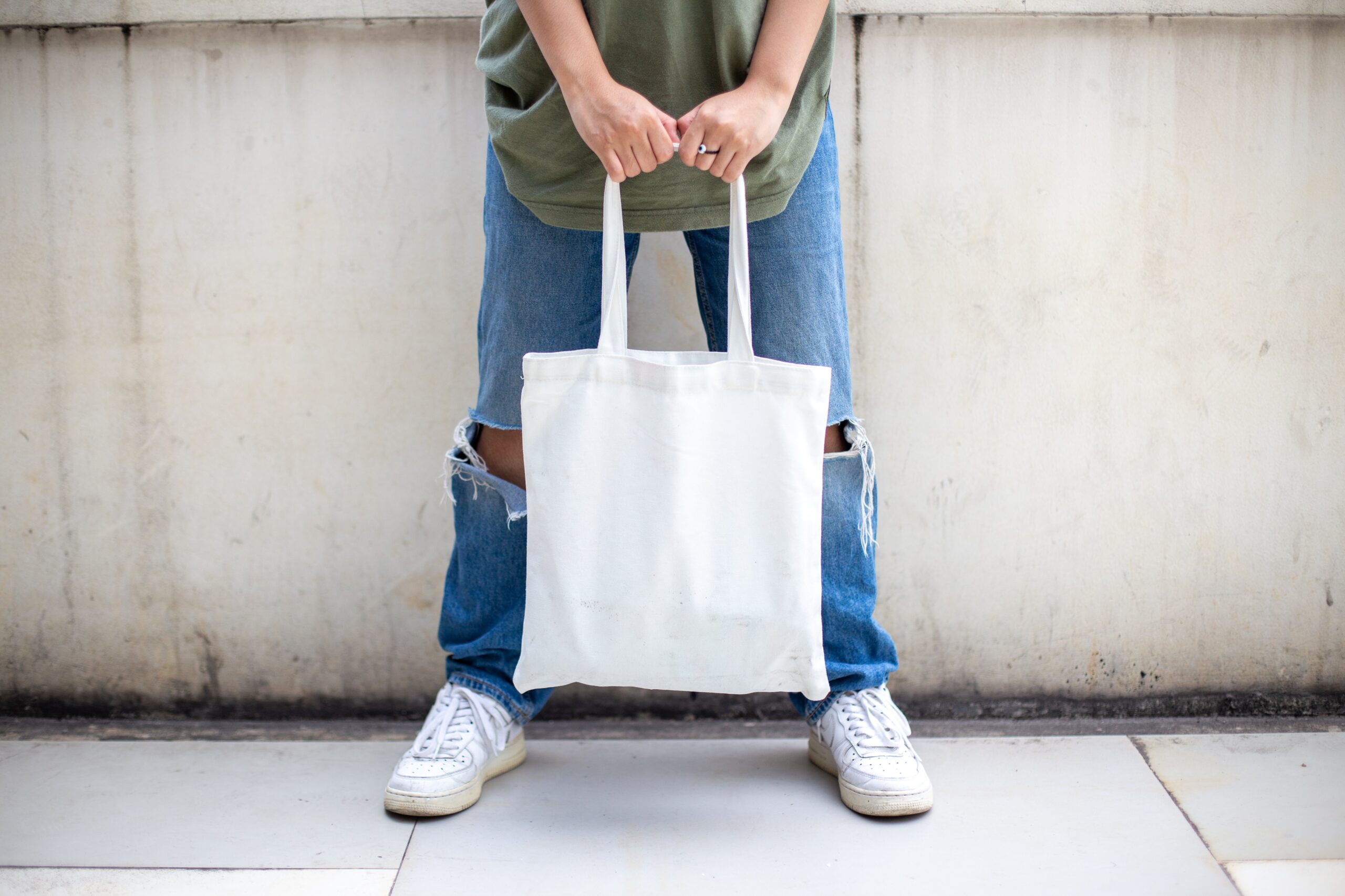 man holding tote bag.