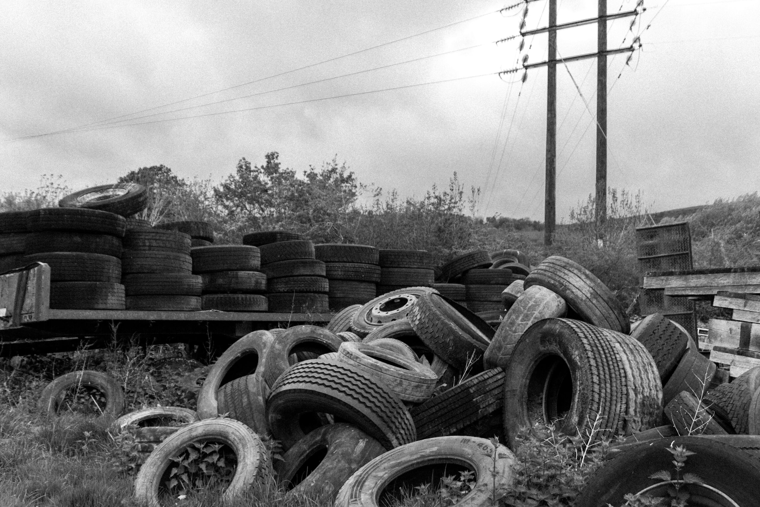 tyres piled up in a yard for disposal.
