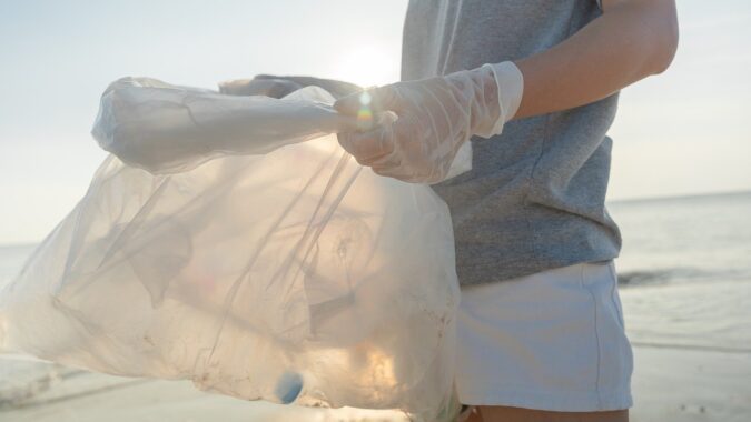 man with bag doing waste audit.