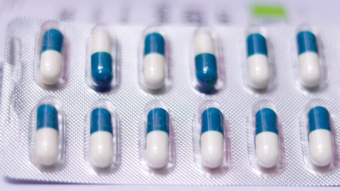 blister pack with blue and white tablets.
