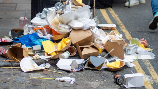 packaging waste in front of a bin.