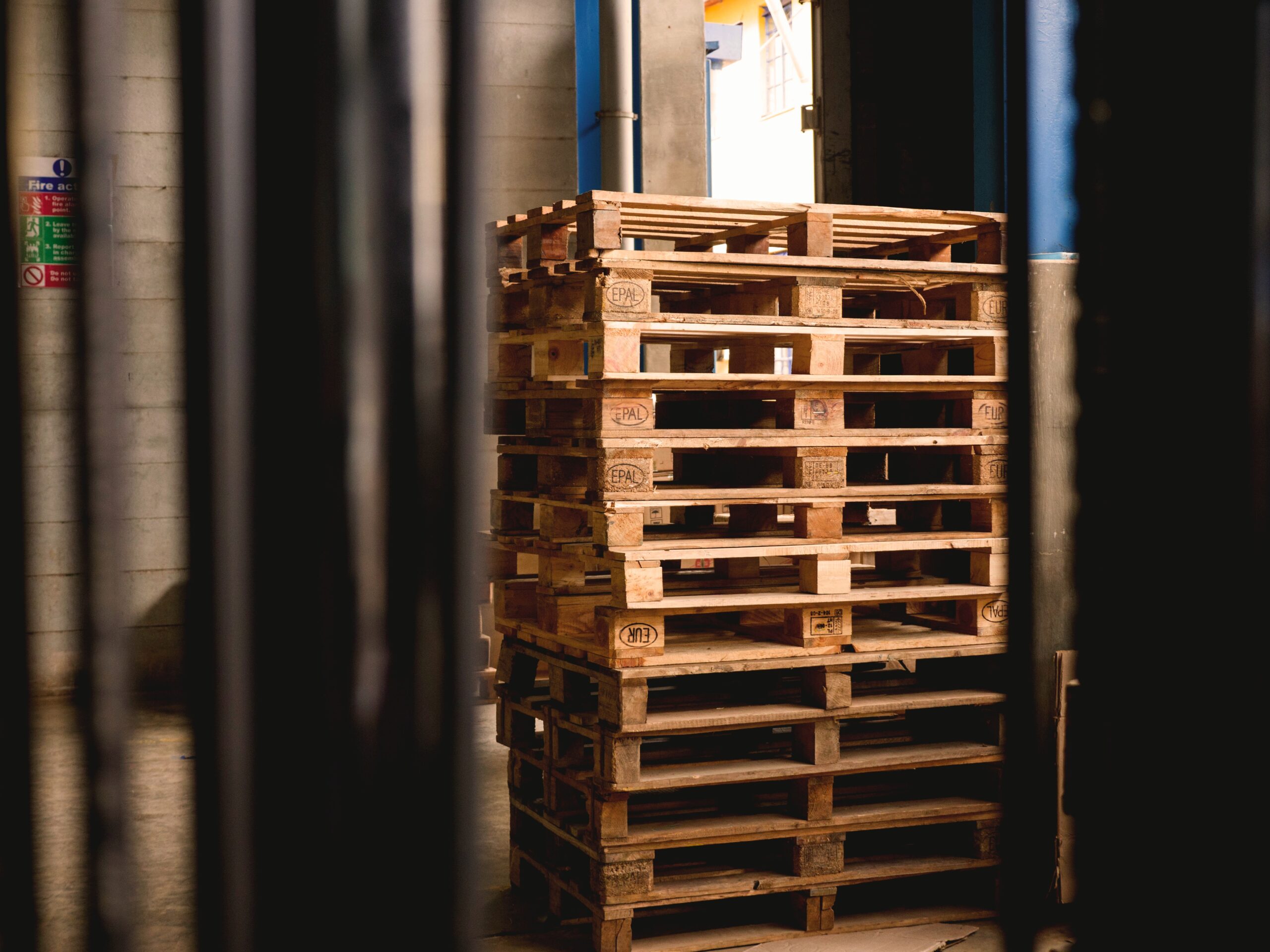 old pallets stacked up in a warehouse.