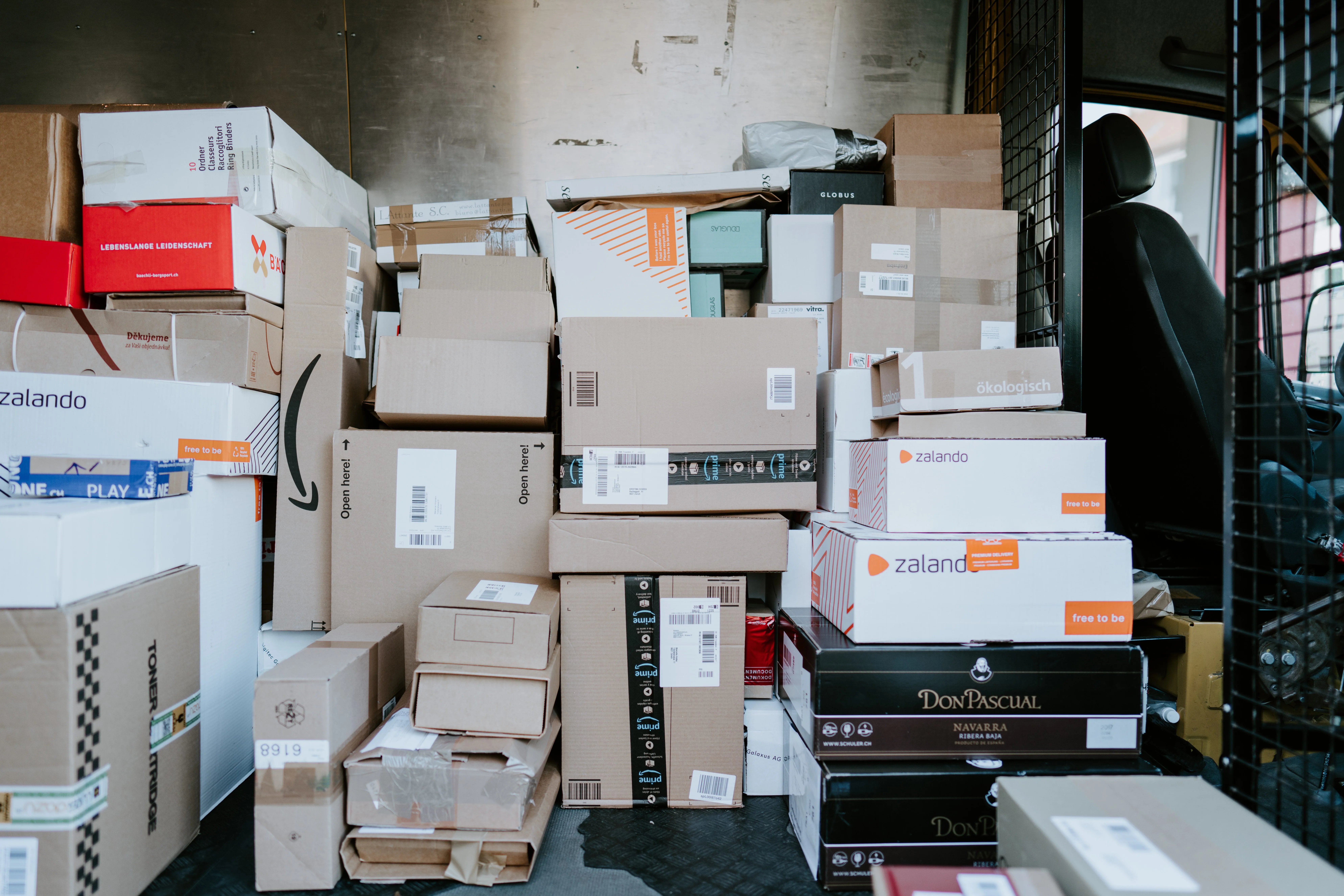 cardboard boxes in the back of a van.