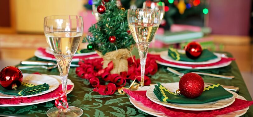 Christmas dinner table set up with champagne glasses.