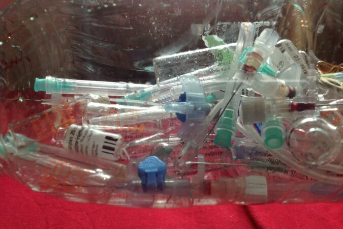 medical waste bucket of syringes.
