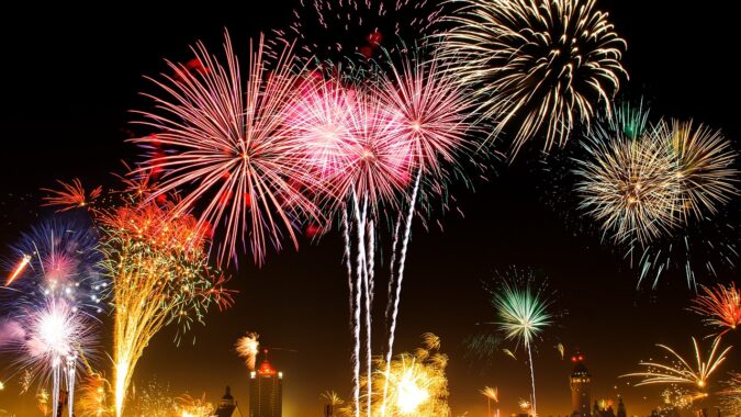 New Year fireworks over a city skyline.