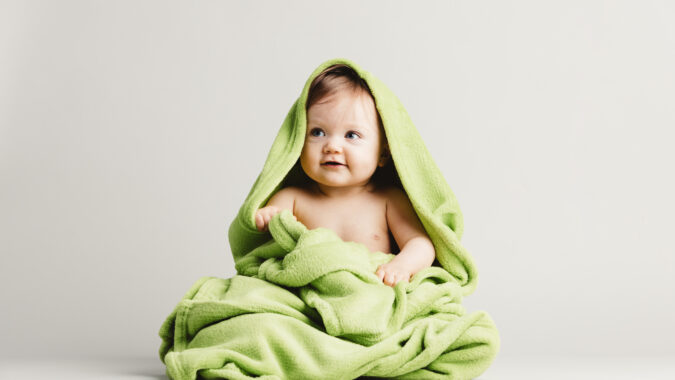 baby sat in a blanket.