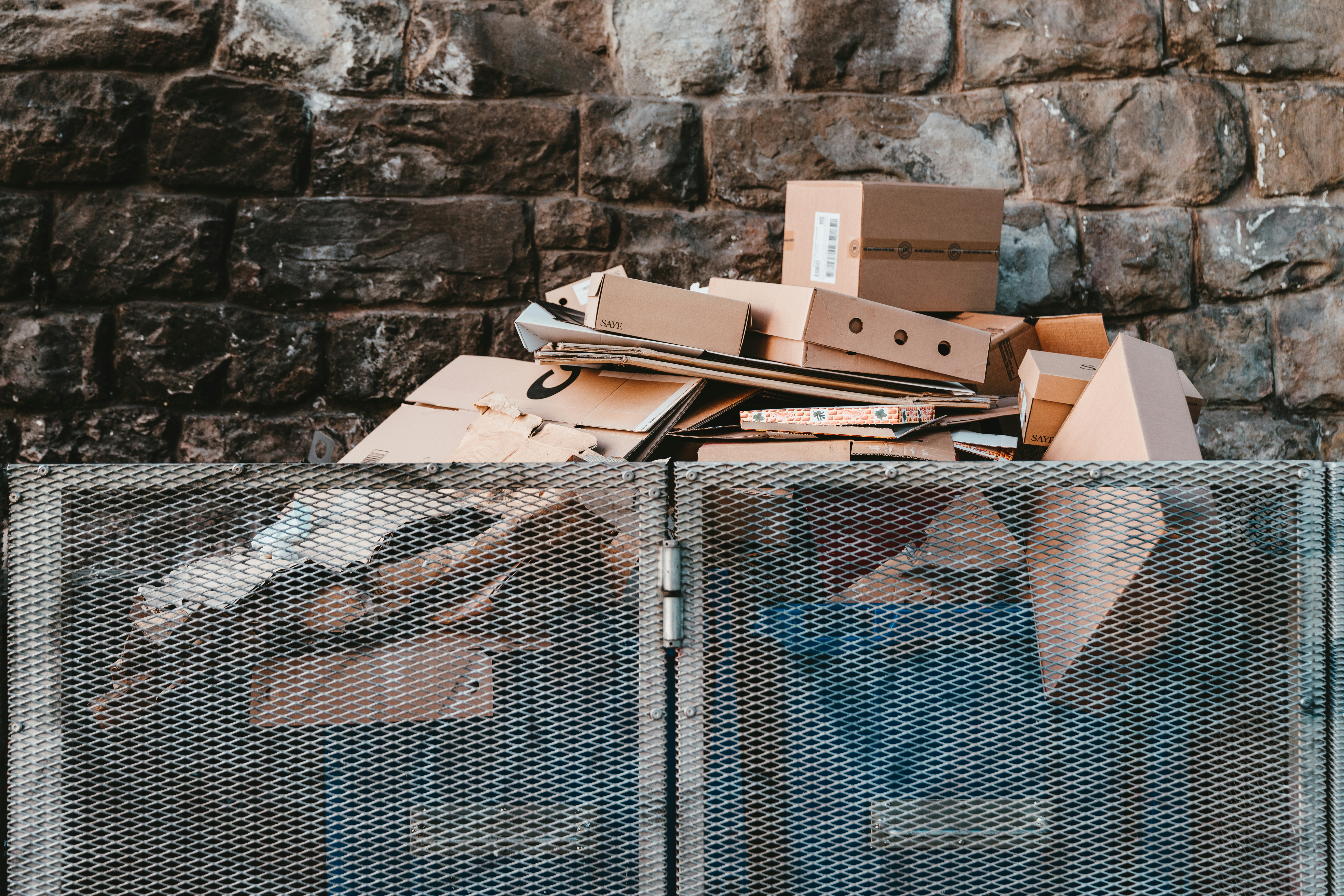 brown cardboard boxes in a bin storage area.