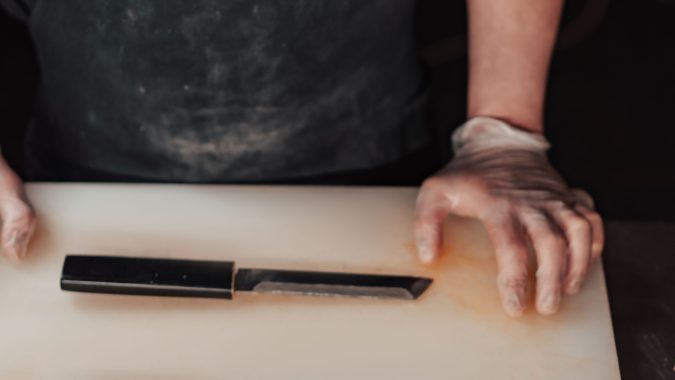 commercial kitchen knives on a board